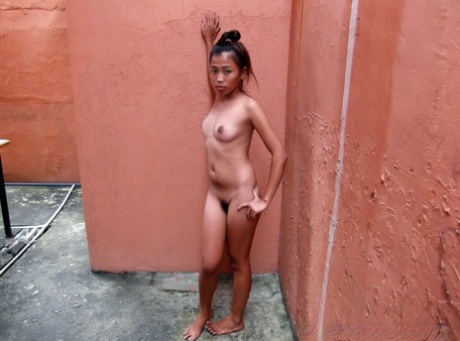 Petite Asian teen poses in the nude at the bequest of a sex tourist