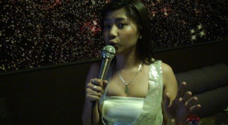 Before having sex with a tourist, Joy, a Filipina girl, sings in a karaoke bar.