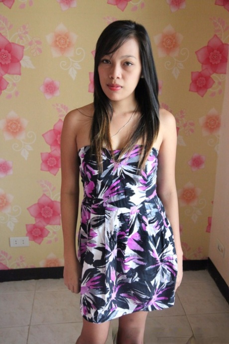 Young Filipino female removes her dress and underwear to pose in the nude