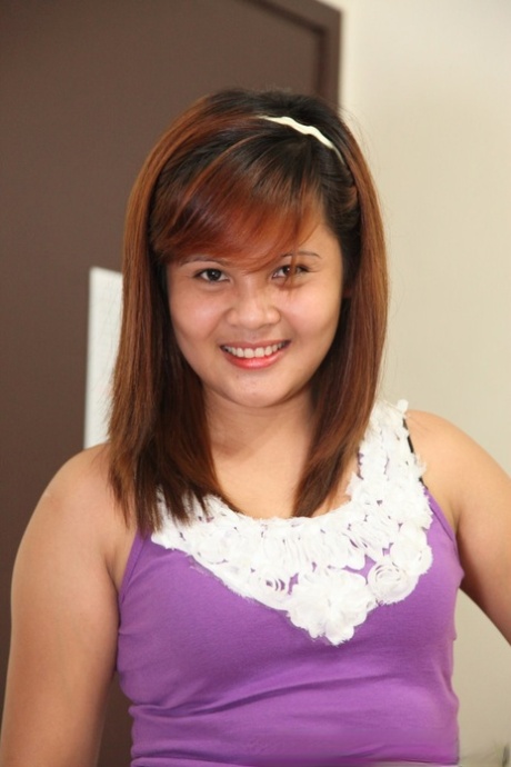 In the picture, a cut Filipina girl removes her skirt and clothes to showcase her trimmed bush.