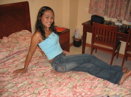 Amateur Asian teen poses in tight jeans and disrobes to give a naked blowjob