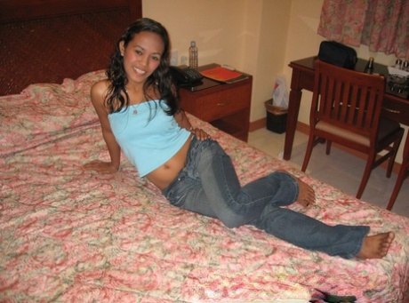 Amateur Asian teen poses in tight jeans and disrobes to give a naked blowjob