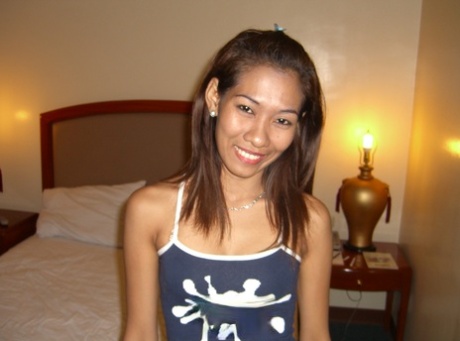 An Asian woman experiences her first nude experience on white sheets.