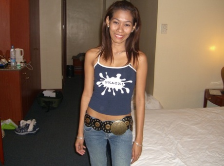 A young Asian contestant experiences a nude first time on white sheets.