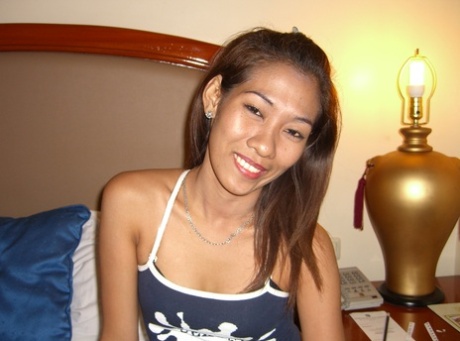 Uncommonly awakened Asian performer lays down on white sheets for the first time, without any clothing or accessories.