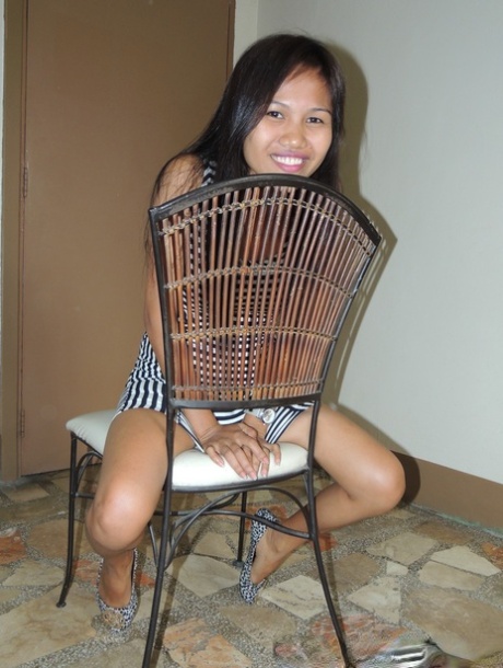 In the company of a sexual tourist, Filipina cutie displays her breasts in a motel room.