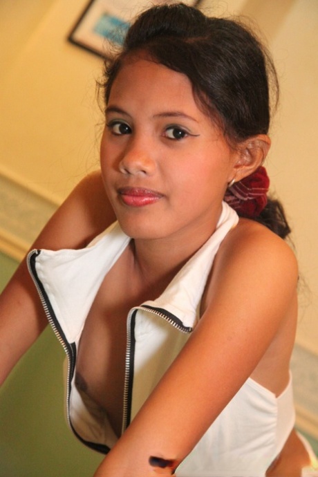 In honor of her 18th birthday, a young girl from the Philippines takes on all-inclusive attire by posing in the nude.