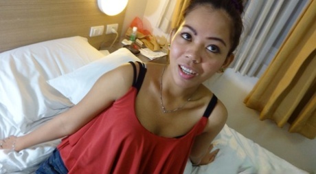 During POV sex, Anne, an Asian amateur, wears her hair up when she engages with a sex tourist.