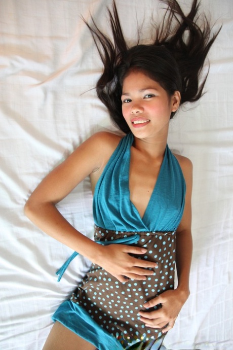 Cute: The cute young 'Asian princess' Anabel strips her lovely dress down and poses naked with her buttocks.