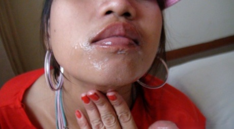 By inserting a ball cap into the vagina, an Asian amateur can receive an open mouth cumshot.