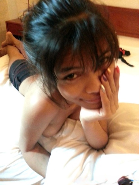 A young Pinay girl exhibits her attractive breasts before engaging in sexual activity.