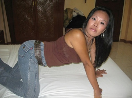 A Filipina amateur exposes herself by putting on denim jeans and covering her thong-covered ass while getting naked.