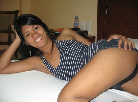Filipina Amateur Strips To A Strapless Black Bra And Thong On A Hotel Room Bed