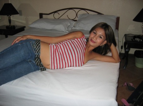 So after taking off her shirt, the pinay bargirl takes to posing in bed on the floor wearing a strapless bra and jeans.