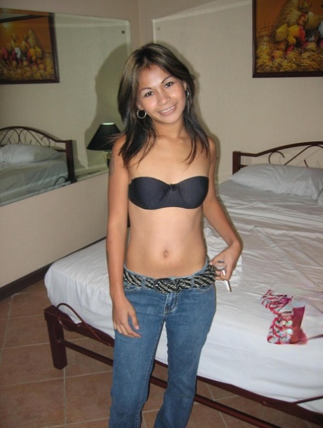 A strapless bra and jeans on a bed prompts the Pinyon to take off her shirt and pose.