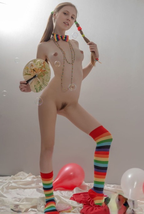 Skinny Teen Girl In Pigtails And Multi-colored Socks Takes Off Her Clothes