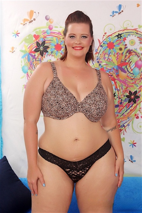 SSBBW Amanda Foxxx removes large breasts from a bra and black panties.