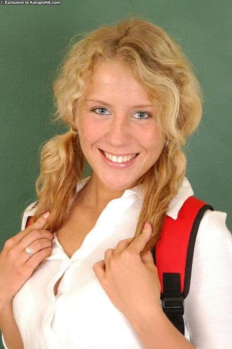 The nude: Young blonde Lita removes her pretty panties before she sits in class.