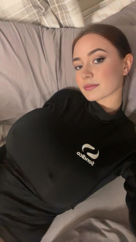 Adorable blue eyed teen with huge juggs Brooke Mills poses in a tight shirt