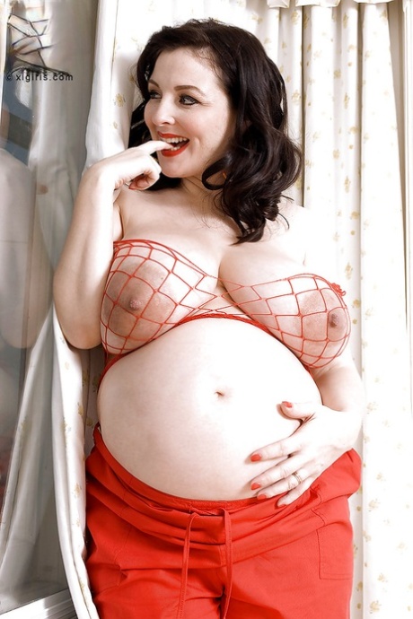 Brunette preggo with fat tits Lorna Morgan posing in fishnet bra and black panties - PornHugo.net