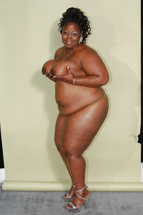 Ebony with a rich, plump body flaunted in high heels showing her fat stomach area