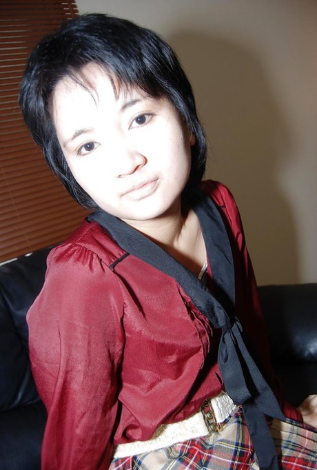 An Asian girl, with short hair, undressed in pantyhose and exposed her twat.