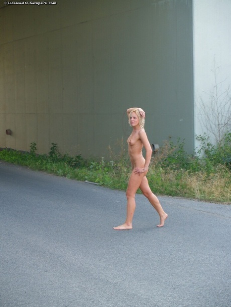 Outdoor enthusiast with playful disposition tappers out to reveal her clenched vagina, while playing outside in the sun.