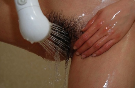 In the shower, an Asian MILF rubbed her hair into its socket.