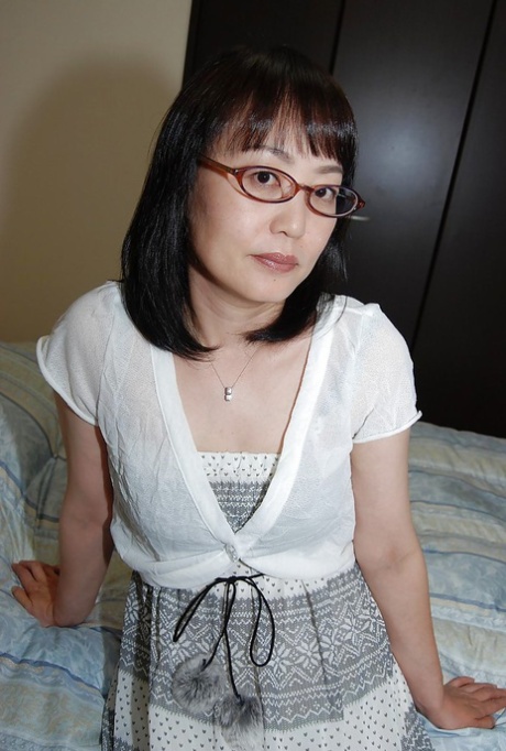 The asian girl wearing glasses pulls her pussy and performs a dare to strip down.