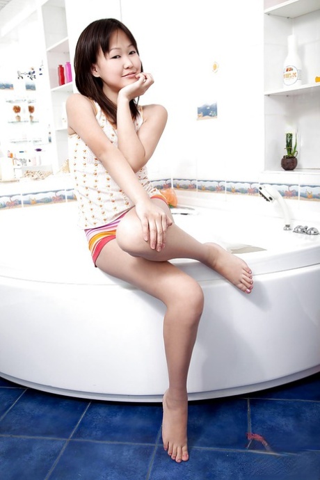 Petite asian teen having bath and teasing herself with water jets