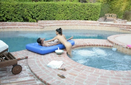 Glamorous Asian babe Asia massages big guy over swimming pool