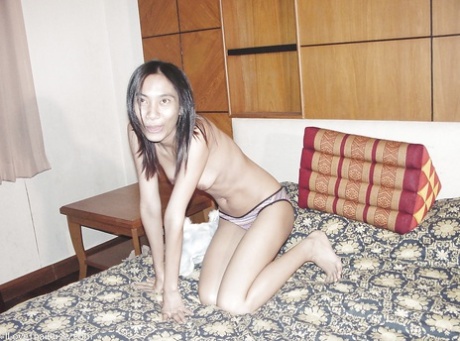 A sultry Asian woman with big tits and moustache, Som is captured on camera naked.