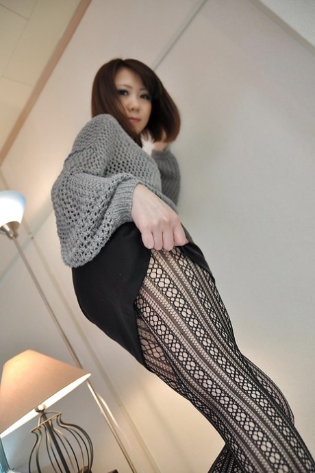 Mari, a stunningly beautiful Asian brunette, looks gorgeous in her black pantyhose.