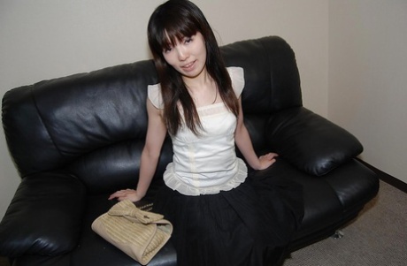 Idumi Haneda, a beautiful brunette with tiny tits, is seen undressing while being photographed.