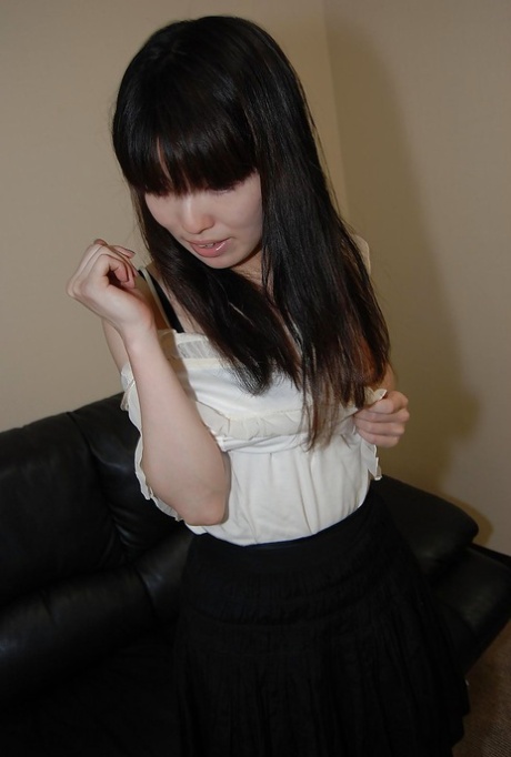 While posing for a photo, Idumi Haneda, a beautiful brunette with tiny tits, is seen undressing.