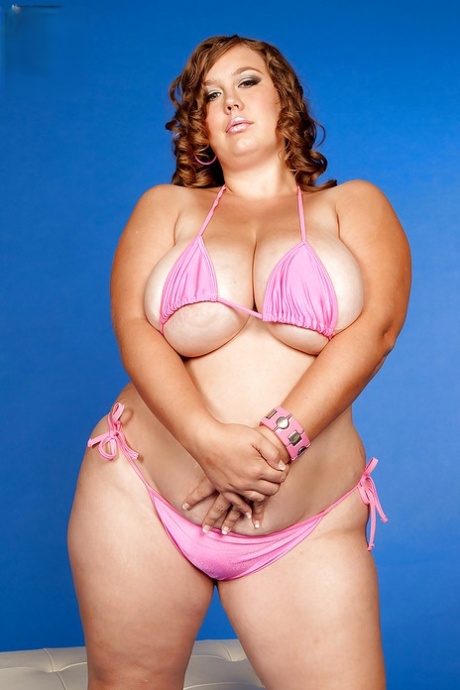 Analee Sands displays her bikini and oversized breasts, as well as her large buttocks.