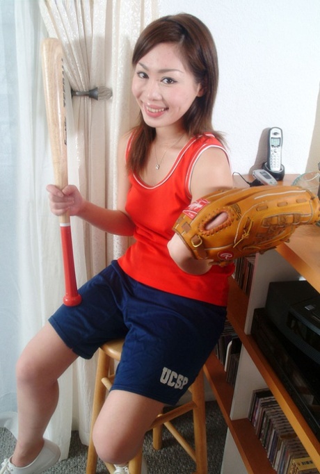 Yumi, the brunette Asian female, teases her amateur pussy with a bat while being discreet.