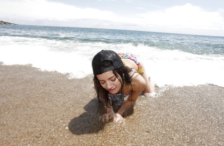 Tiny tits teen babe Alicia Poz reveals her Asian ass on the beach