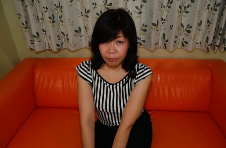 Asian milfolk with big tits RuRiko Hirai spreads her legs.