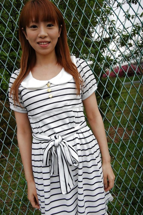 In her sexy striped dress, Chihiro Ozawa, an Asian, is seen walking outside.