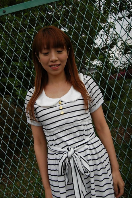 The striped dress worn by Asian Chihiro Ozawa is seen walking outside in her desired attire.