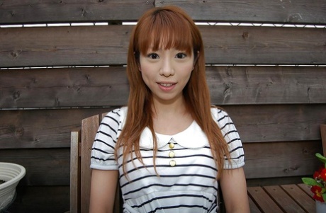 In her striped dress, Chihiro Ozawa, an Asian, is seen walking out.