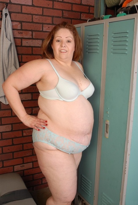 Cyn, a fat and mature woman, is captured on camera as she slowly takes off her clothes in the locker room.