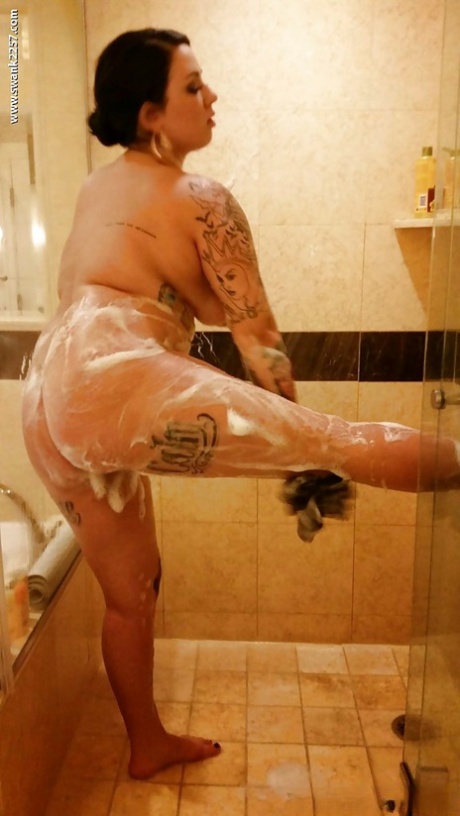 During the shower, Brianna Rose plays with her sensual body while sporting tattoos.