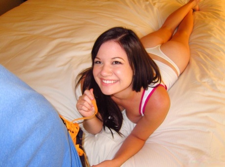 An Asian woman, Alison Rey, sucks her penis with great force.