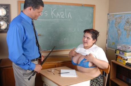 In class, Karla, a fat girl, treats her dominant teacher with a handjob.