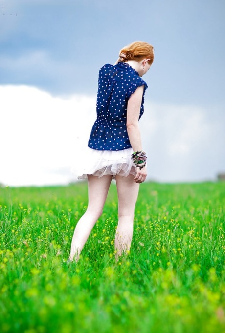 Outdoor photo of Isadora, a redheaded young dog with armpits and hairy muff.