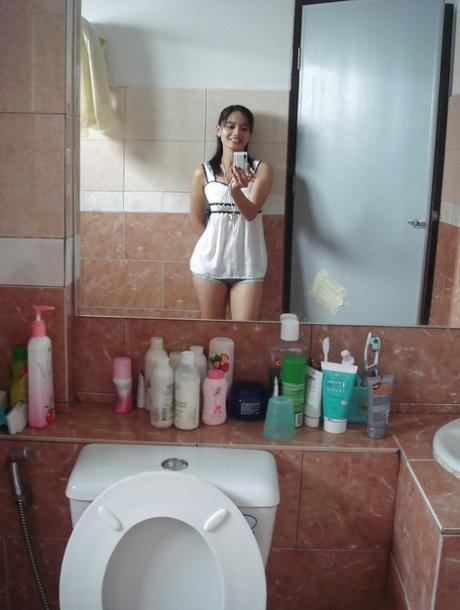 A tiny Thai girl shares stories of getting shot before stripping naked in the bathroom.
