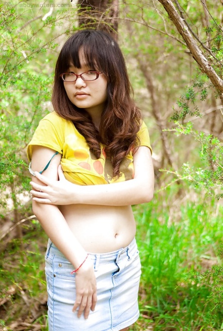 A small Asian woman with glasses bares her hairy vagina outside the body after a slow removal of hair.