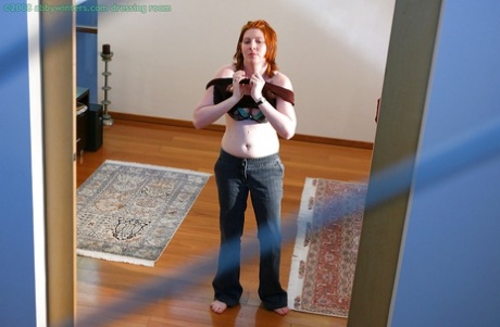 All natural redhead are captured on a hidden camera as they pull their pants over their soft anals.